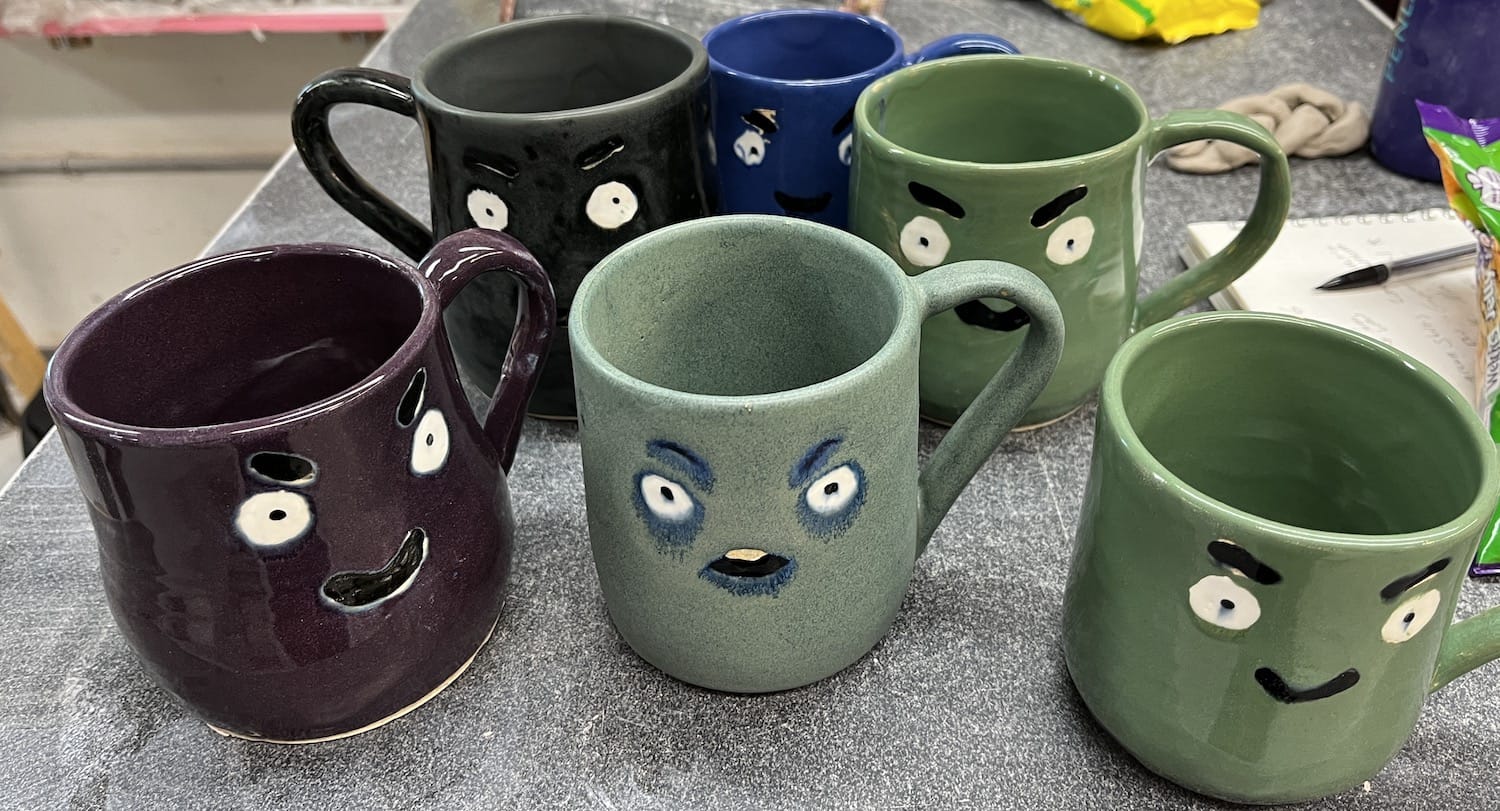 Ceramic mugs with faces, made by Shana